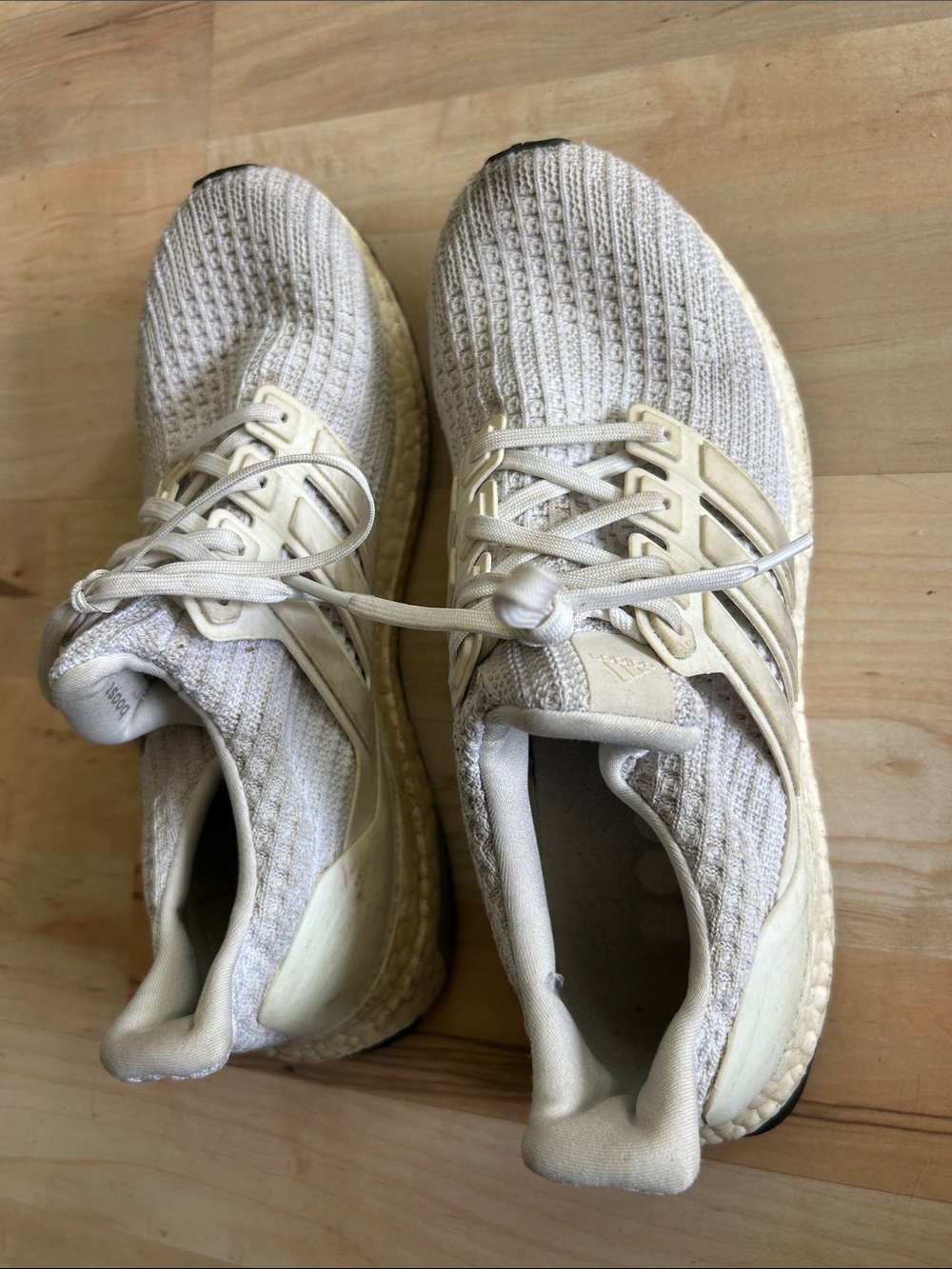 white Adidas Ultraboost 4.0 athletic sneakers.